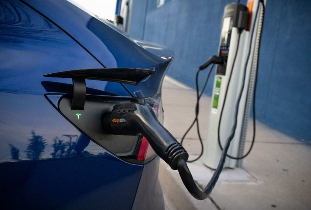 Image of Electric vehicle is charged at charging station in Albuquerque