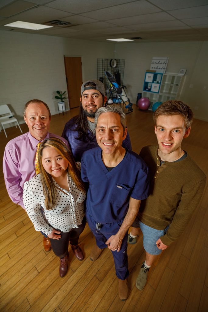 PAIN POINT — From left, Ingenuity Software Labs CEO John Mierzwa and Just Health Care front-end designer Jenilee Jao, Internet of Things designer John Valdez, Chief Technology Officer Andru Zeller and machine-learning designer Asher May. Through the NMSBA program, Sandia helped Just Health Care LLC improve technology that helps clinicians quantify and locate a patient’s likely pain source. (Photo by Bret Latter)