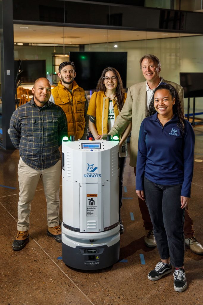 ROBOT ROUNDUP — From left, Build With Robots Director of Sales Xavier Lemon, Marketing and Community Engagement specialist Christian Slough, Robotics Engineering intern Lauren Baca, Chief Strategy Officer and co-founder Matthew Ennis, and Marketing associate Tyanne Hawthorne. NMSBA’s Disinfecting Robot Leveraged Project received the Honorable Speaker Ben Lujan Award for Small Business Excellence.(Photo by Bret Latter)