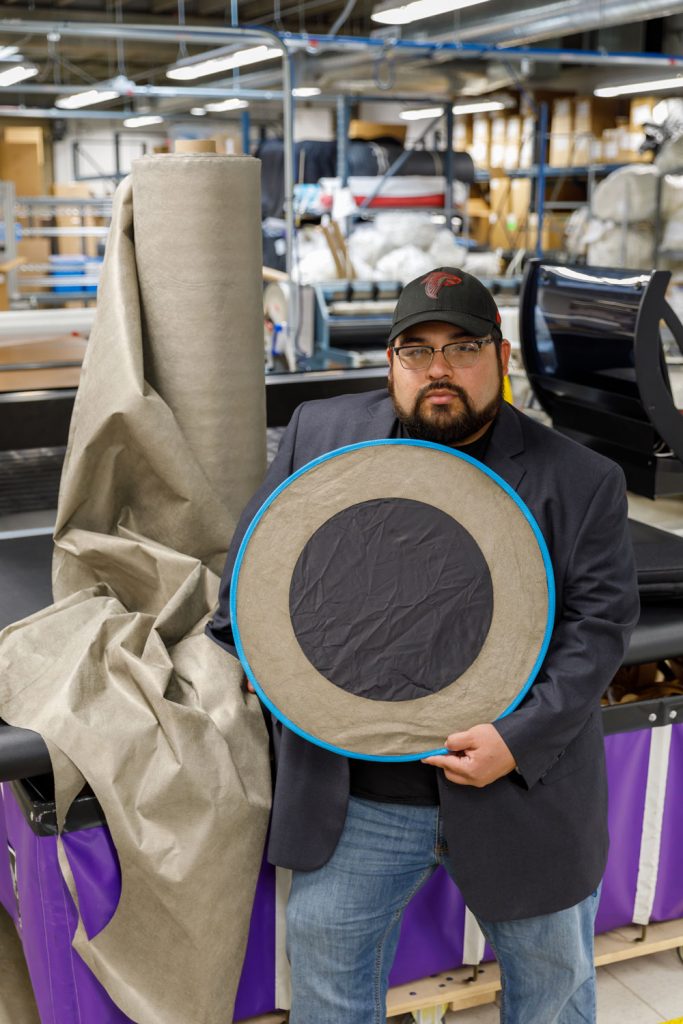 Image of Optical Radio Communications Technology Chief Technology Officer Joshua Benavidez holds a passive signal booster