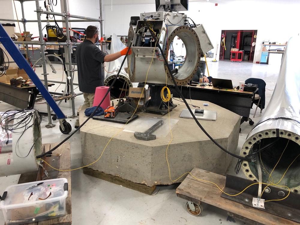 Image of n engineer tests rotor blade instrumentation at the National Rotor Testbed in a Lubbock, Texas