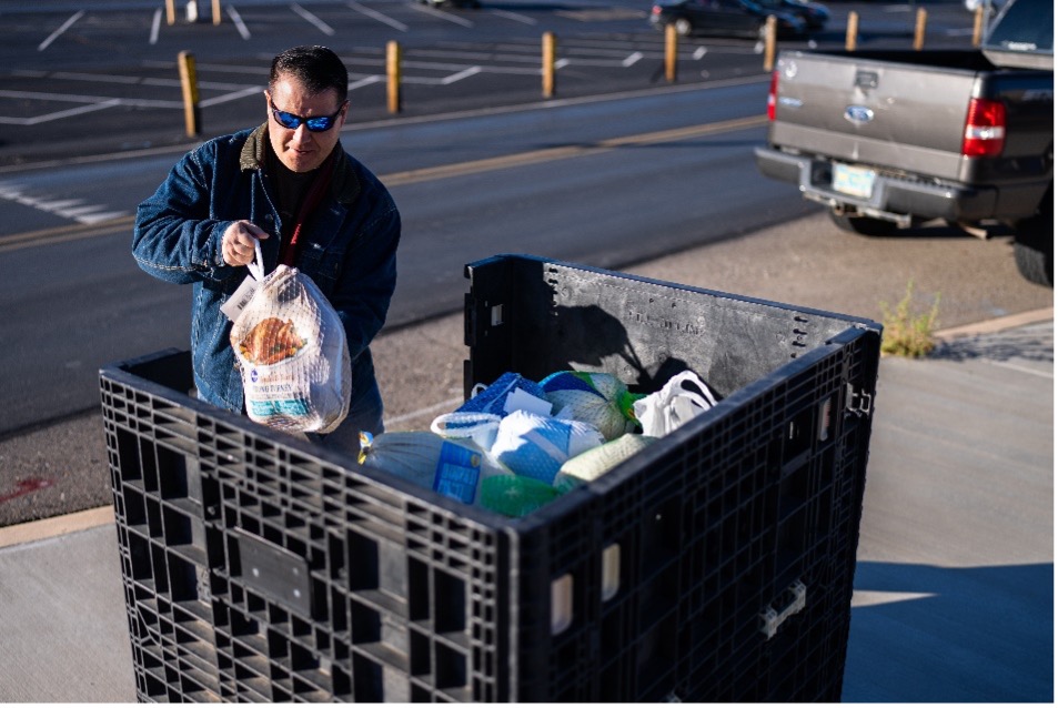 TURKEY COLLECTION — Electrical engineer Mario Martinez drops off a turkey near the Steve Schiff Auditorium on Tuesday. (Photo by Craig Fritz)