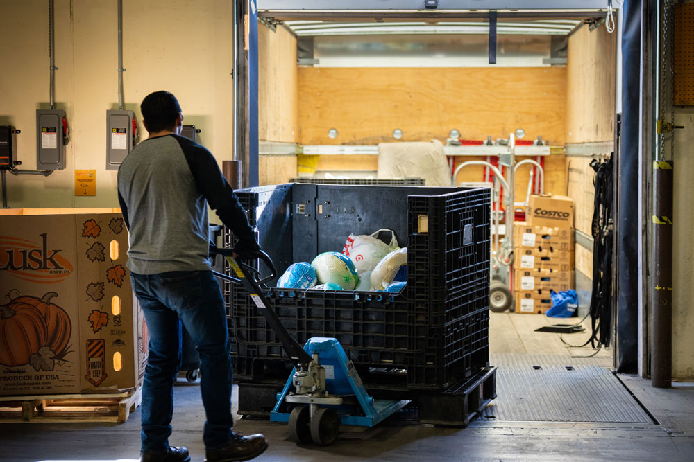 COOL DONATIONS — Frozen turkeys collected from Sandia Labs and Sandia Laboratory Federal Credit Union are unpacked at Roadrunner Food Bank on Tuesday. (Photo by Craig Fritz)