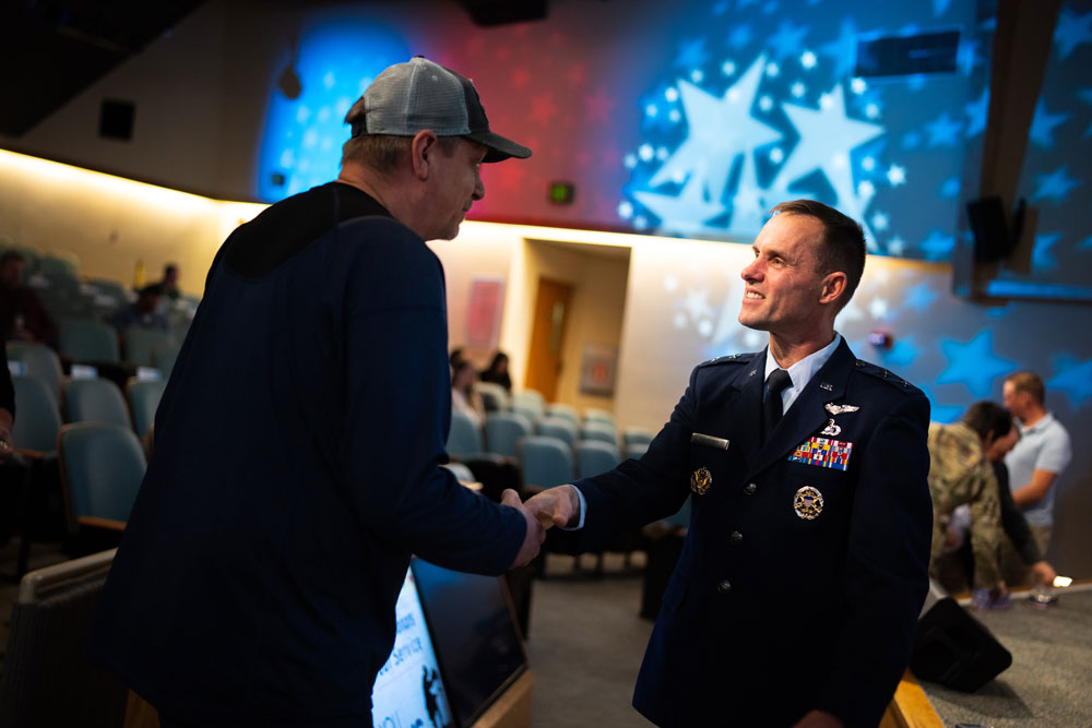 Image of Maj. Gen. John Newberry, right, honors Sandia technologist Scott Waddle with challenge coin