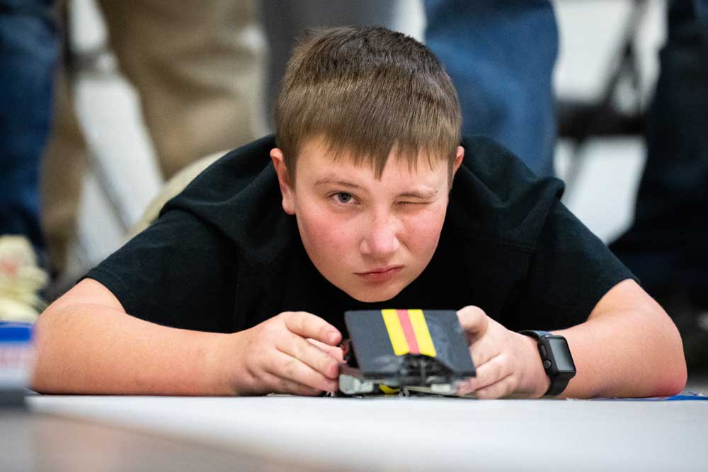 Image of Student focuses on building his car at the New Mexico Electric Car Challenge