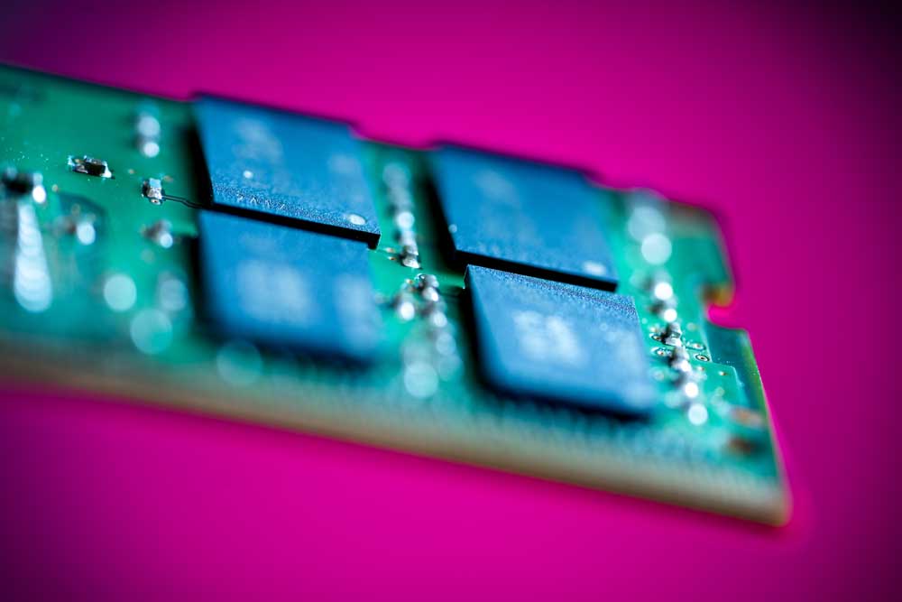 MAXIMIZED MEMORY — A Sandia team is collaborating with Los Alamos and Lawrence Livermore national labs and Intel Federal LLC to optimize DRAM packages, pictured here and found in many consumer laptops, to increase compute platform performance. (Photo by Craig Fritz)