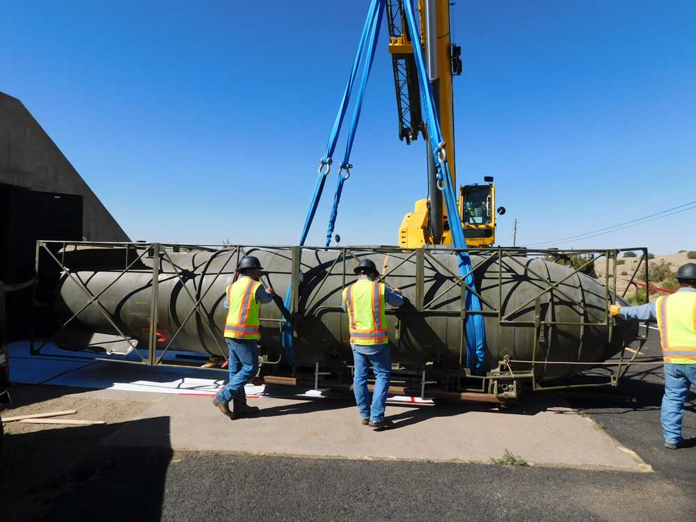 MAKING MOVES — The team carefully removes the 25-ton nuclear bomb trainer from a storage facility for transport to Kirtland Air Force Base. (Photo by John Korbin)