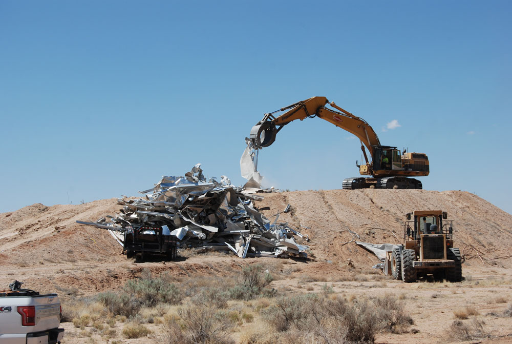 TAKE ONE DOWN — Contracted crews demolished a major test fixture, the liquefied natural gas pool fire facility, in 2022. A massive dome was built on top of an earth-berm reservoir dirt hill, pictured here, to hold 52,000 gallons of LNG. (Photo by Janise Baldo)