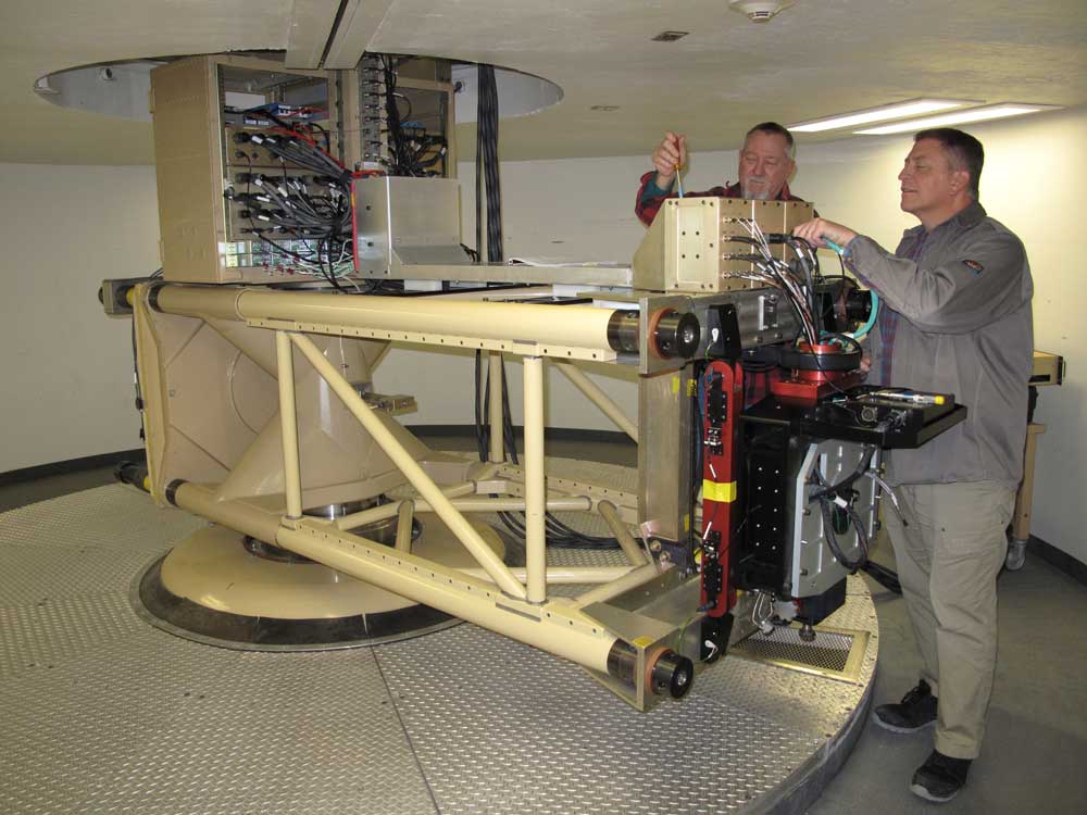 TEST PREP — David Lander, left, and Jason Cochran prepare a centrifuge for a test at Sandia’s Weapons Evaluation Test Laboratory in Amarillo, Texas. (Photo by Larry Kuykendall)