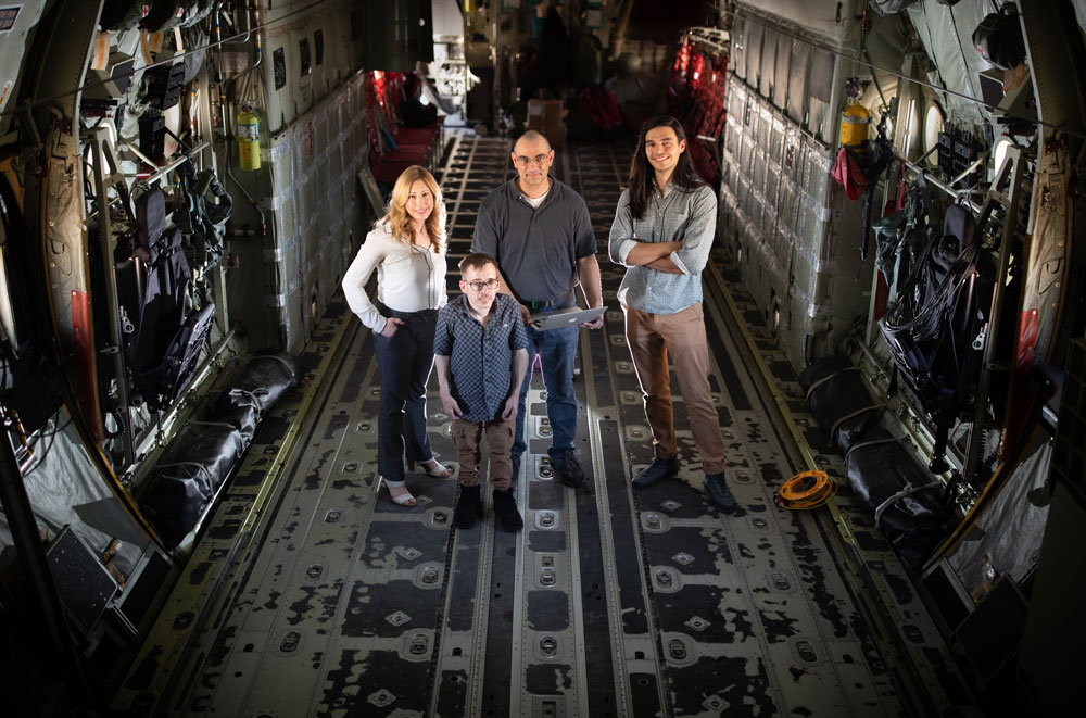 AIR DEFENSE — Aboard the 58th Special Operations Wing’s C-130 transport aircraft at Kirtland Air Force Base, Christy Sturgill, Jacob Hazelbaker, Eric Vugrin and Nicholas Troutman, from left to right, were part of the Sandia team working on a moving target defense that makes a computer network commonly used on space and aircraft less vulnerable to cyberattack. (Photo by Craig Fritz)