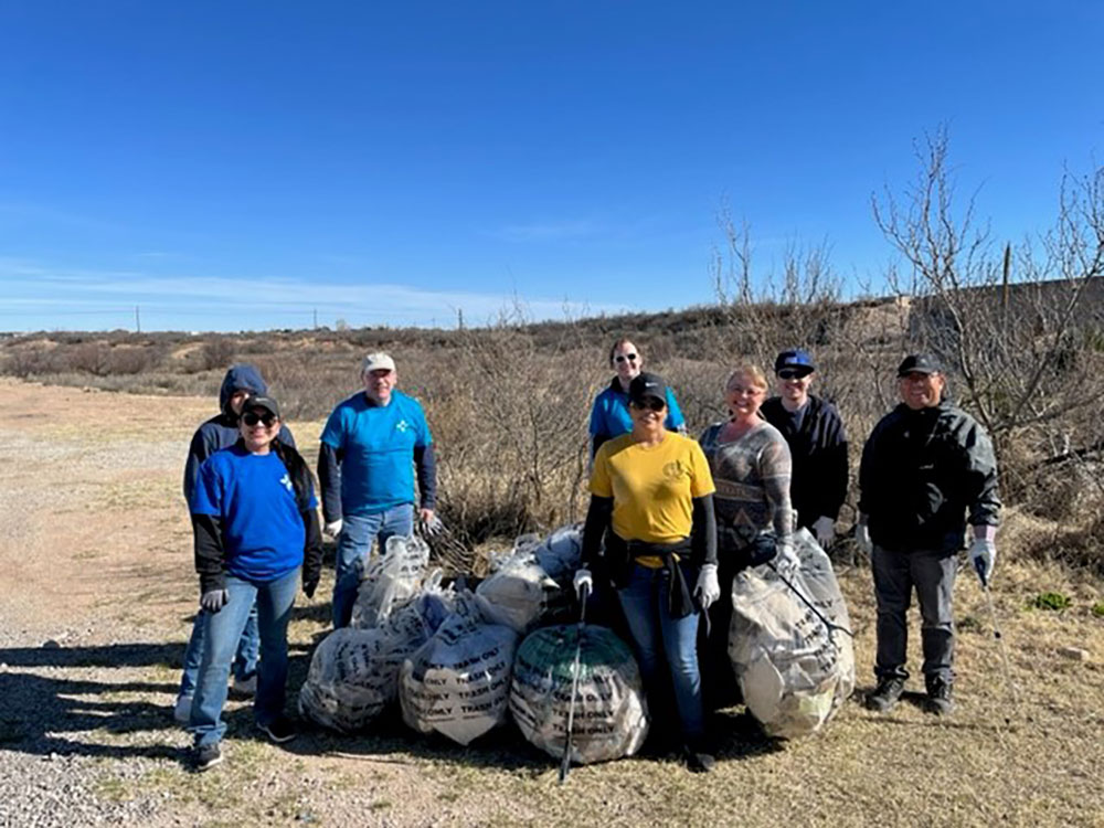 Image of A team of Sandians in Carlsbad, New Mexico, pick up trash along the Pecos River