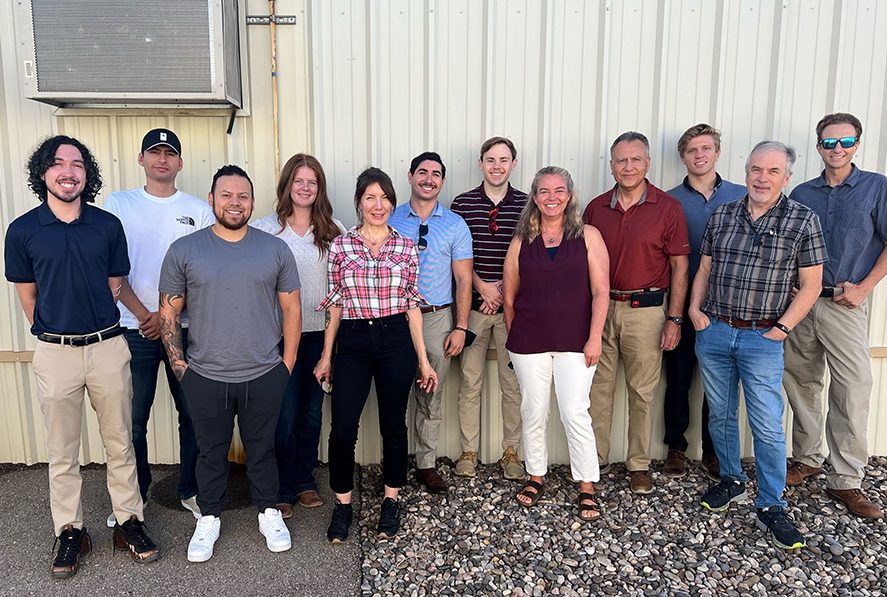 Image of Sandia's Energy Management team poses in front of a building