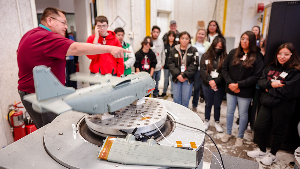 THE FEEL OF HOME — Mechanical engineer Fernando Bitsie, who attended the same high school in Gallup, New Mexico, as many of the students on the tour, shares his career story and conducts a vibration simulation at a Sandia environmental test lab. (Photo by Craig Fritz)