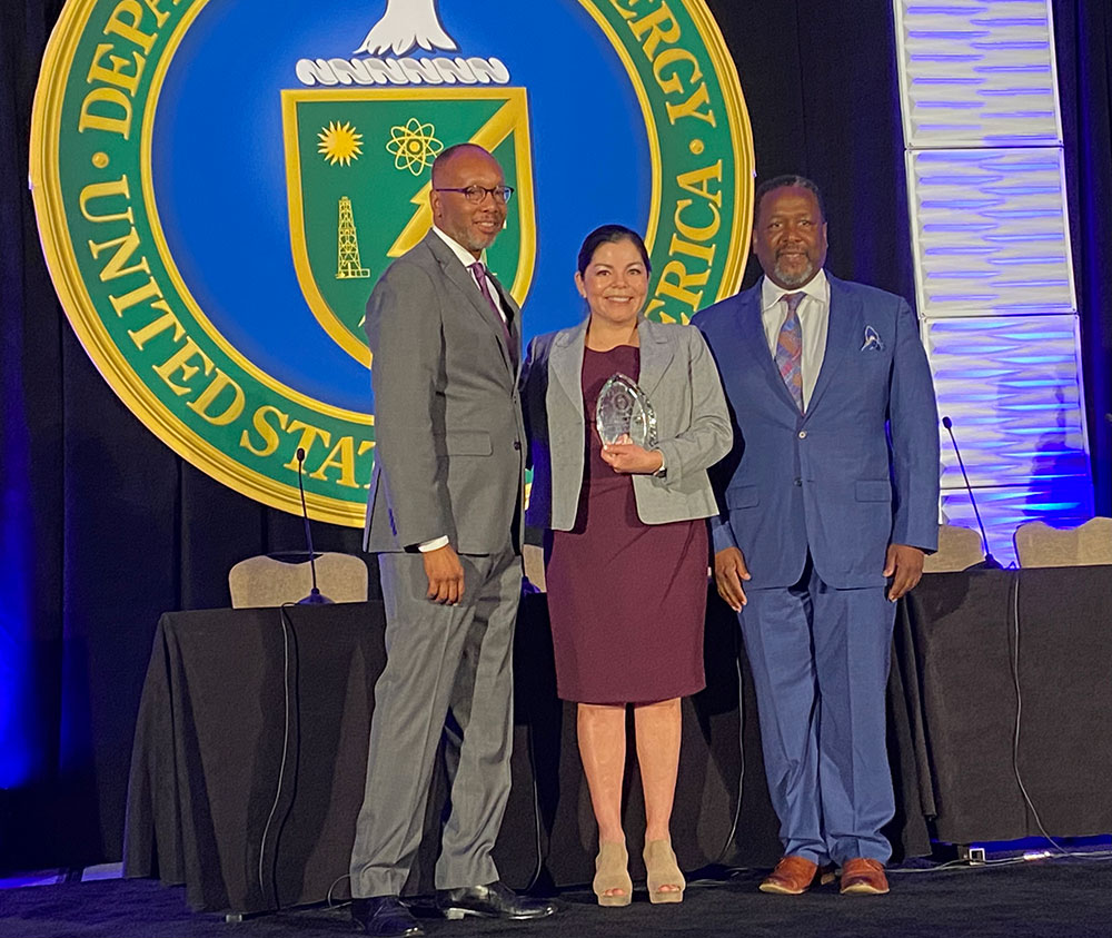 SMALL-BUSINESS ADVOCATE — Sandia Supply Chain Subcontract Manager Sofia Delgadillo-Marrufo, center, receives the Facility Management Contracting Officer of the Year award for her successful partnership with small business CeLeen through the Mentor-Protégé Program. (Photo by Patricia Brown)