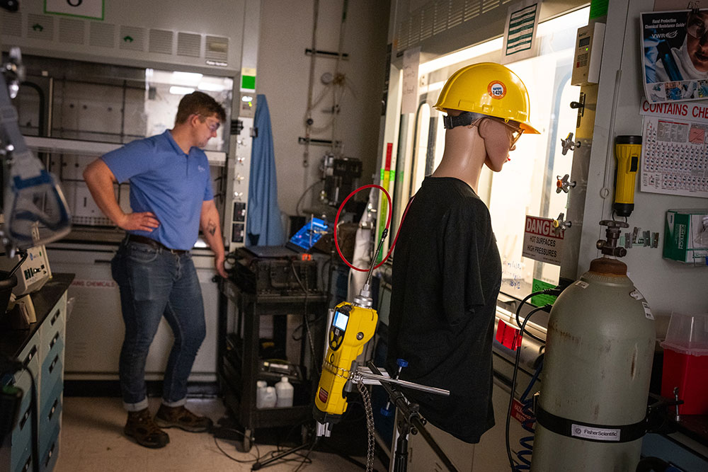 GREEN UPGRADES — Contractor Walker Smith tests fume hoods after performing energy-efficient upgrades as part of Smart Labs. (Photo by Craig Fritz)