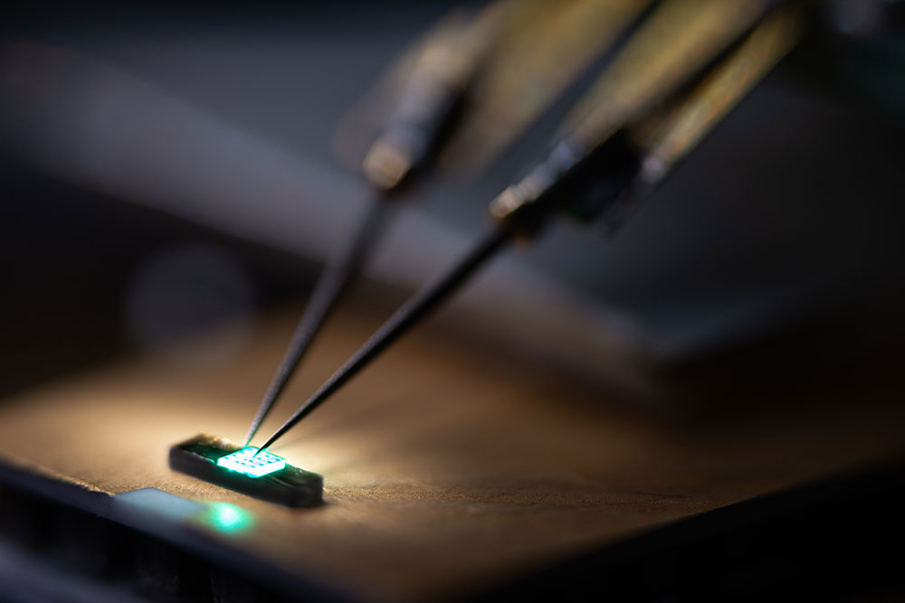 TESTING LASERS — A probe is used to test a green indium gallium nitride laser diode being developed at Sandia for next-generation quantum sensors. (Photo by Craig Fritz)