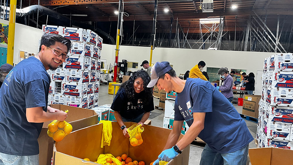 FRESH PRODUCE — Sandia California staff packaged oranges, apples and plums at the Alameda County Community Food Bank for delivery to smaller neighborhood meal programs. The food bank received $7,000 from Sandia to provide nourishing food to people experiencing food insecurity. (Photo by Michelle Walker-Wade)