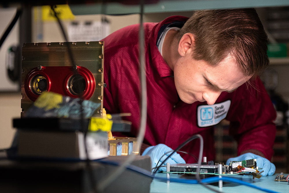 LAB TESTING — Thomas Bradshaw, lead computer engineer for the project, prepares a payload for integration testing. (Photo by Craig Fritz)