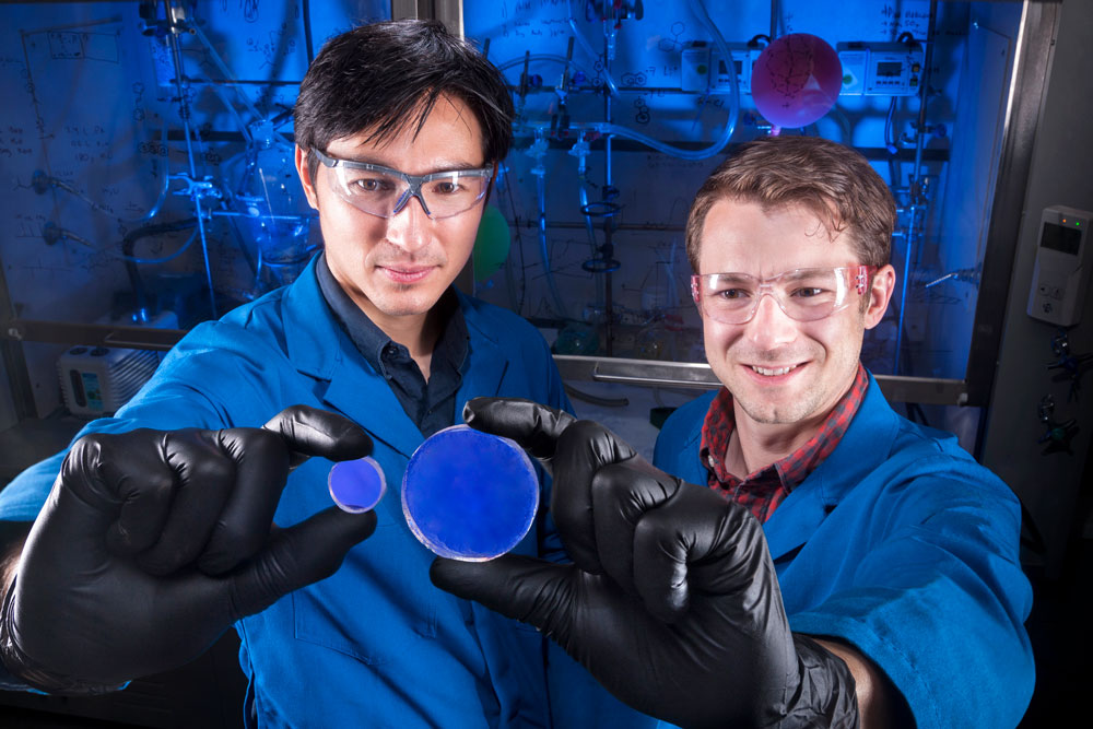 ADVANCING RADIATION DETECTION — Sandia researcher Patrick Feng, left, and former Sandian Joey Carlson, hold Organic Glass Scintillators they helped create to detect radioactive materials. (Photo by Randy Wong)