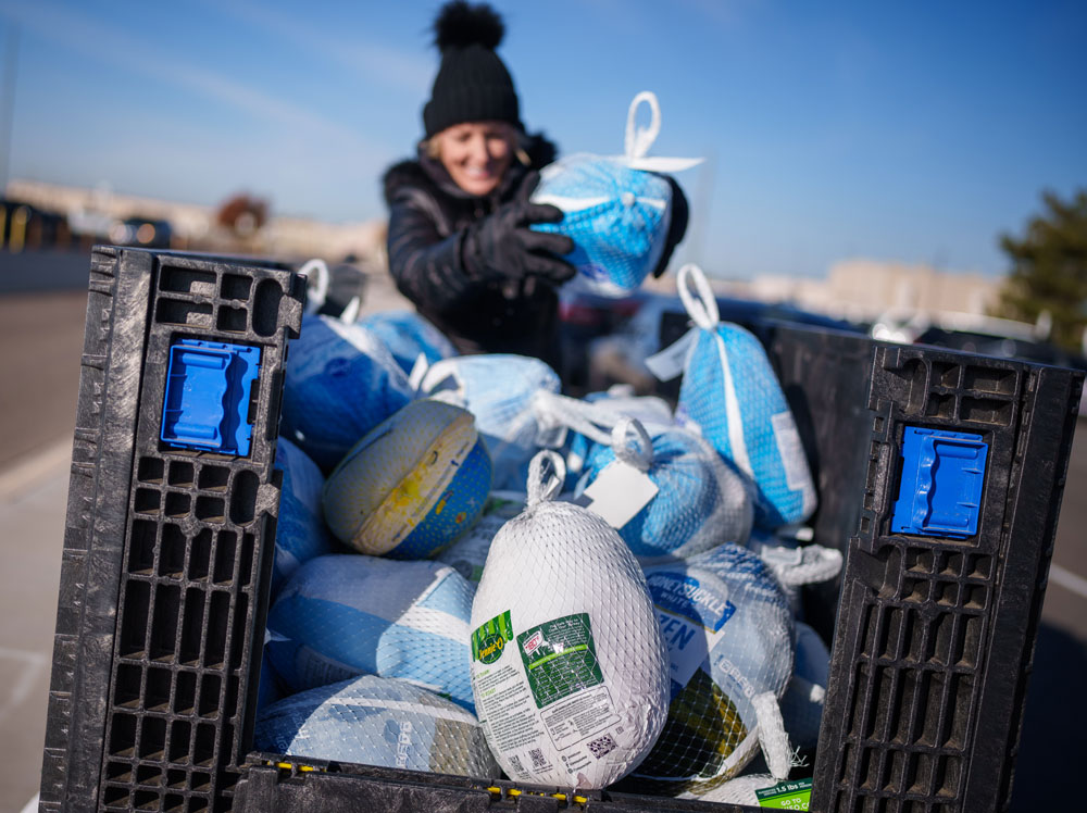PILED HIGH — Community Relations Specialist Debra Menke supervises turkeys as they are dropped off near the Steve Schiff Auditorium during Sandia’s Take a Frozen Turkey to Work Day. (Photo by Craig Fritz)