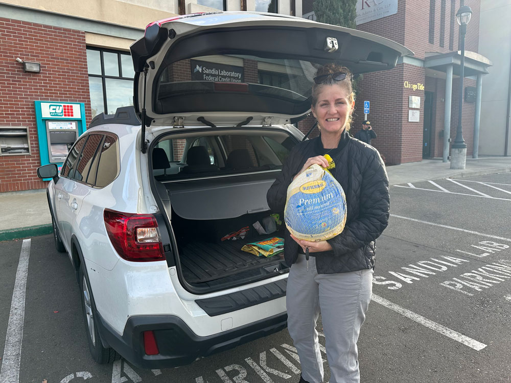 TURKEY TROT — Florencia Prada, senior manager of Business Operations and Human Resources, drops off a frozen turkey in Livermore, California, on Tuesday. This is the first year Sandia’s California site participated in Take a Frozen Turkey to Work Day. (Photo by Michael Skaikh)