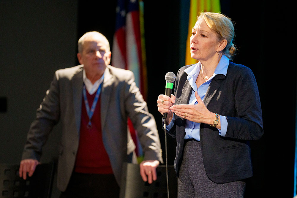 BEHAVIORS DRIVING SUCCESS — Deputy Laboratories Director Laura McGill, right, with Associate Labs Director for Stockpile Management, Components and Production Steve Girrens listening on, addressed a live and online audience at a nuclear deterrence all-hands meeting Nov. 28. Laura and Steve emphasized how Sandia’s corporate behaviors — acting courageously, being purpose-driven and connecting with others — work in concert with the recently launched nuclear deterrence portfolio strategy. The three strategy pillars of simplifying, empowering and partnering are directly connected to the Labs behaviors and are embedded in how work gets done. During the meeting, employees shared stories showcasing how their embrace of the pillars and behaviors help Sandia meet its goals to deliver on its commitments without sacrificing safety and reliability. (Photo by Craig Fritz)