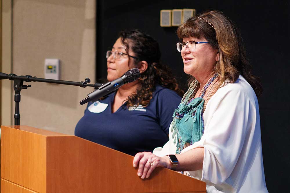 SANDIA WOMEN’S CONNECTION — SWC Co-Chair Pam Lober, right, speaks to honorees with Alejandra Dominguez.