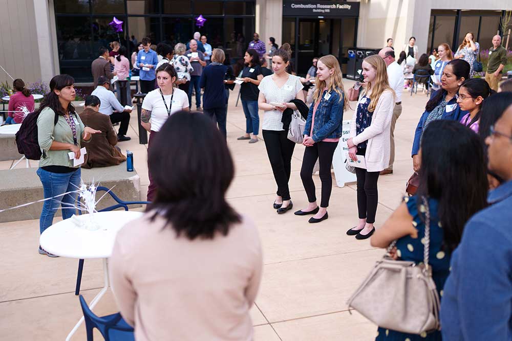 MEETING OF THE MINDS — Award recipients and Sandia mentors share stories outside the California auditorium.