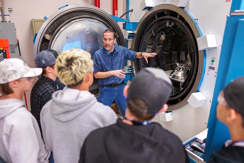 EXPLORING OPPORTUNITIES — Ed Arata shows welding students from Rio Rancho Public Schools the brazing lab during a visit on April 12. (Photo by Craig Fritz)