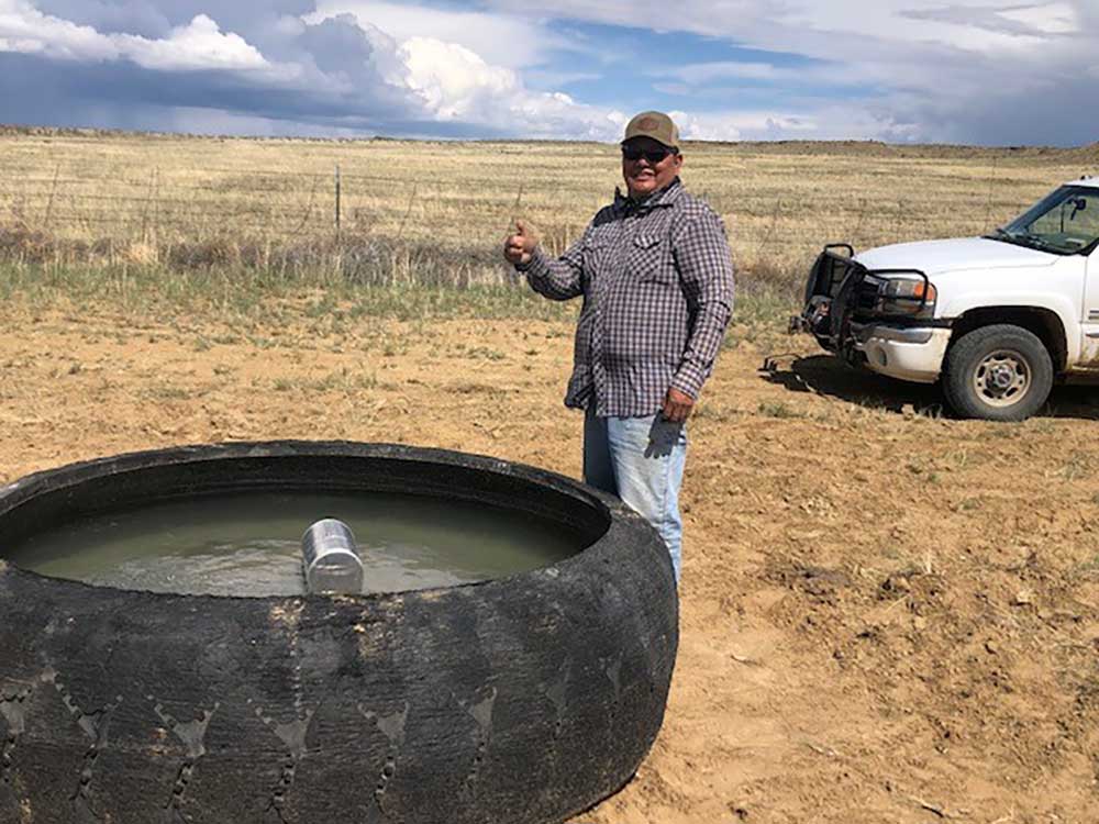 STAMP OF APPROVAL — Rancher Dean Gamble gives a thumbs up to new water pumping technology developed by Remote Well Solutions and Sandia that distributes water across his ranch on the Navajo Nation. (Photo courtesy of Mike Lisk)