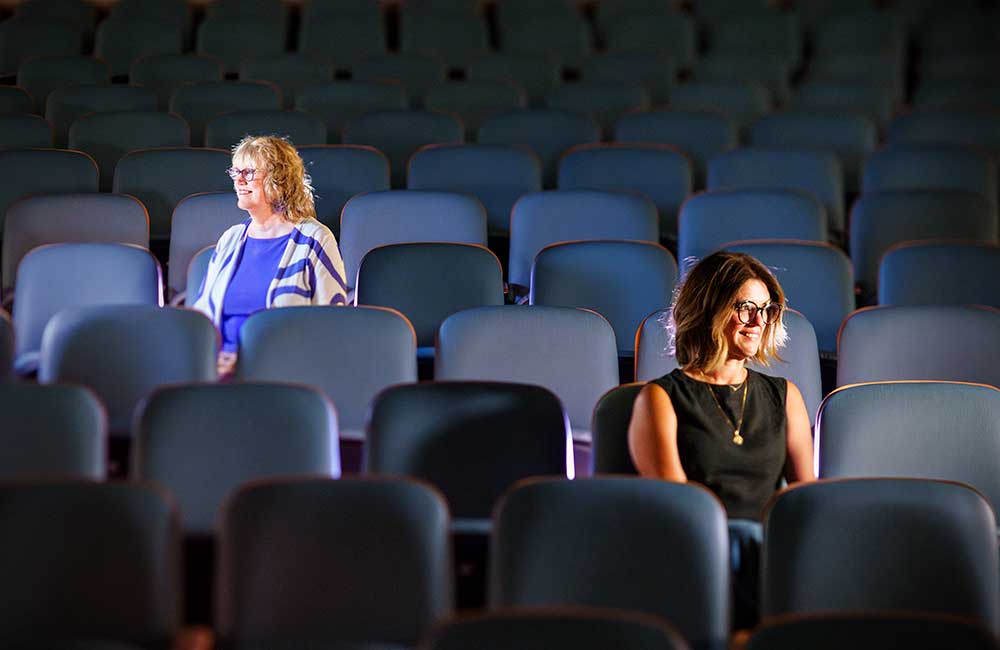 GOOD EARS — Laura Sowko, left, who is deaf in her right ear and writer Magdalena Krajewski, who is deaf in her left, are highly aware of their seating arrangements whether it be in Steve Schiff Auditorium or at the dinner table. (Photo by Craig Fritz)