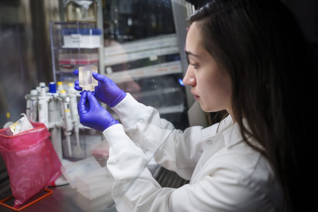 COLLABORATING FOR INNOVATION — Sandia’s Brittany Humphrey holds a microneedle. As part of a Cooperative Research and Development Agreement, Sandia has made changes to the shape of microneedles to speed up extraction of interstitial fluid. (Photo by Craig Fritz)