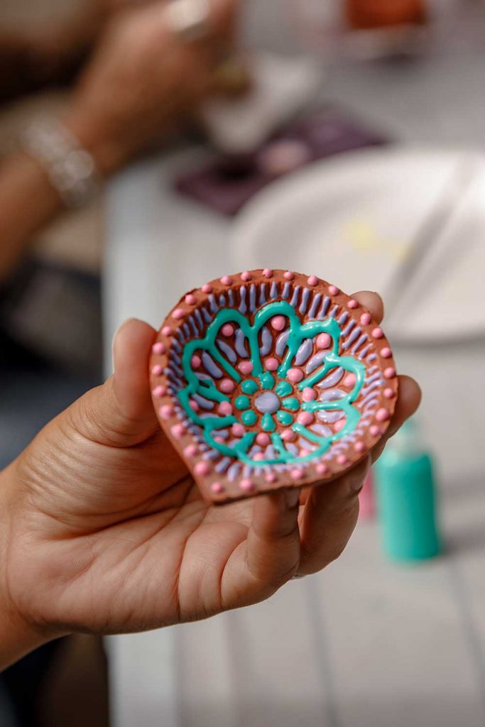LIGHT THE DARK — Attendees of the Diwali event at Sandia California painted small candle holders as part of the festivities.
