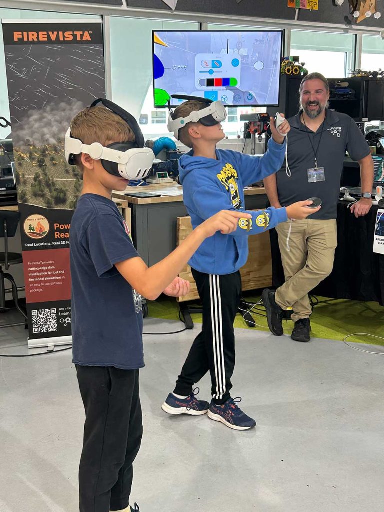 ALTERNATE REALITY — Twin brothers from Tennessee build a virtual room using headsets and software created by SciVista during XR Demo Day at Explora. XR Demo Day participants immersed themselves in augmented reality, mixed reality and virtual reality created by Sandia and other companies. (Photo by Kim Vallez Quintana)