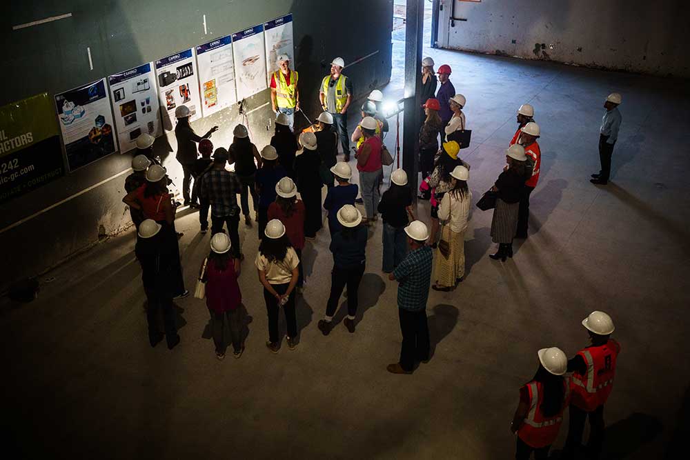BEHIND THE SCENES — More than 30 people gather for a hard hat tour to learn more about Sandia’s Center for Advanced Manufacturing and Innovation. The tour was held for Commercial Real Estate Women of New Mexico to describe some of the intricacies and considerations of setting up a facility for advanced manufacturing. (Photo by Craig Fritz)