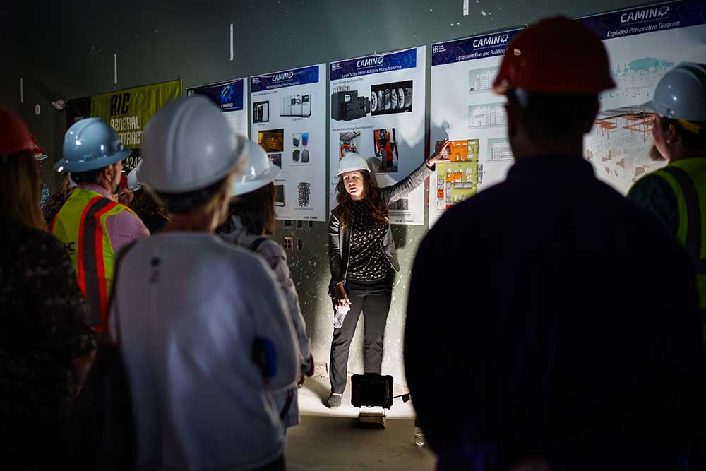 INSIDE SCOOP — Sandia’s Erica Douglas leads a hard hat tour at the Center for Advanced Manufacturing and Innovation. The new center will tentatively open in 2026 and will support Sandia’s national security missions. (Photo by Craig Fritz)