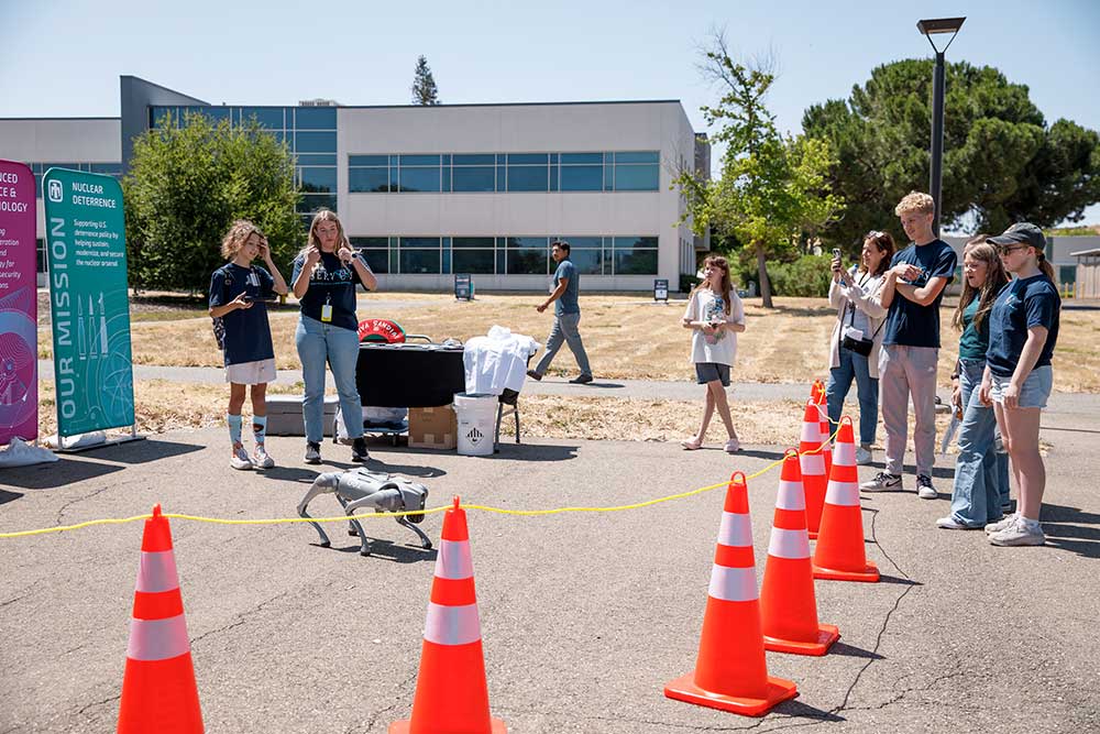 DOG DAYS — Amelia Harrison, second from left, teaches kids how to operate Chip Watson the robot dog during the Kids Day and Stronger Together employee wellness event. (Photo by Spencer Toy)