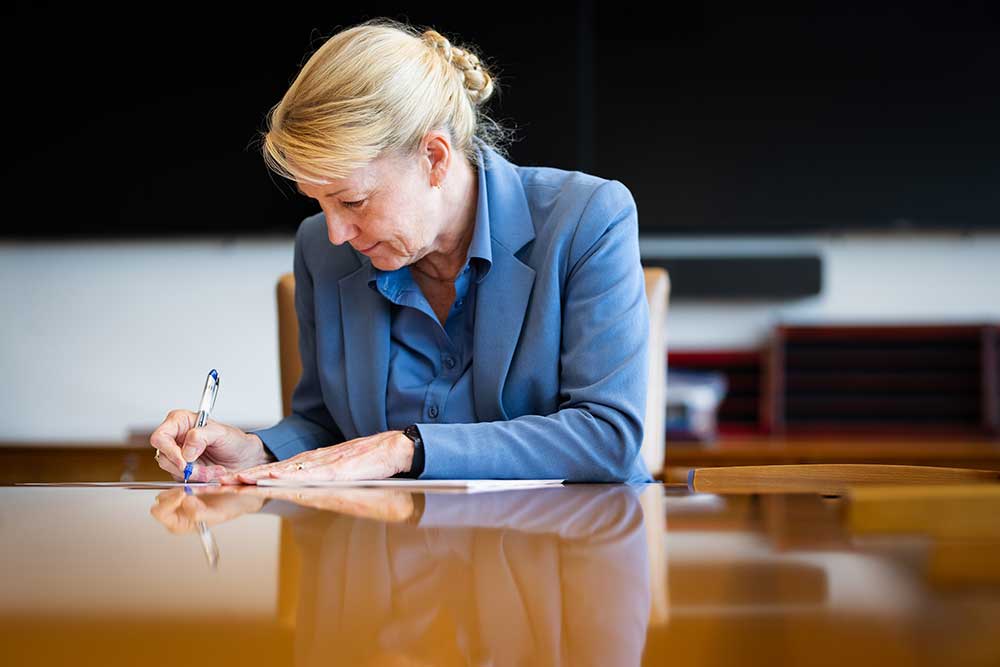 ANNUAL ASSESSMENT — “It’s an honor to sign the letter,” said Labs Director Laura McGill, while finalizing the annual stockpile assessment certification in her office on Sept. 22. (Photo by Craig Fritz)