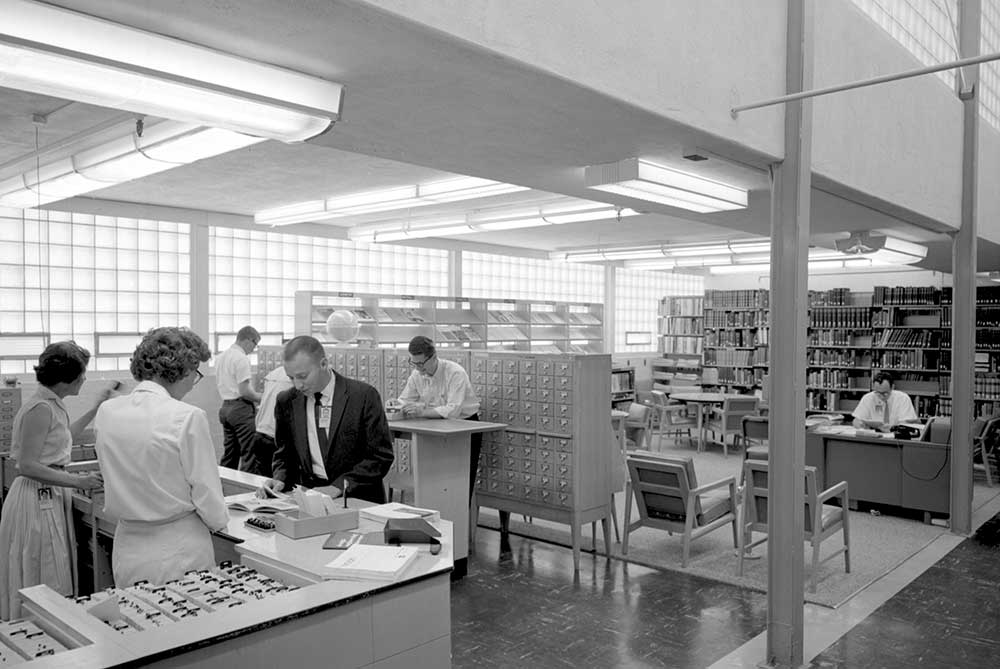 HISTORICAL GATEWAY — Sandians review research in the technical library in 1965. (Photo from the Lab News archives)
