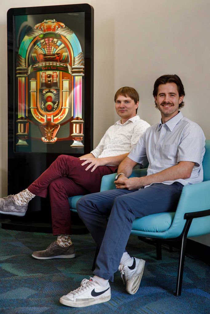 QUANTUM THINKERS — Daniel Hothem, left, and Jeremiah Hauth are part of a team that developed a machine-learning method to make quantum computing more efficient, which they liken to improving a jukebox without having to open it. (Photo by Spencer Toy)