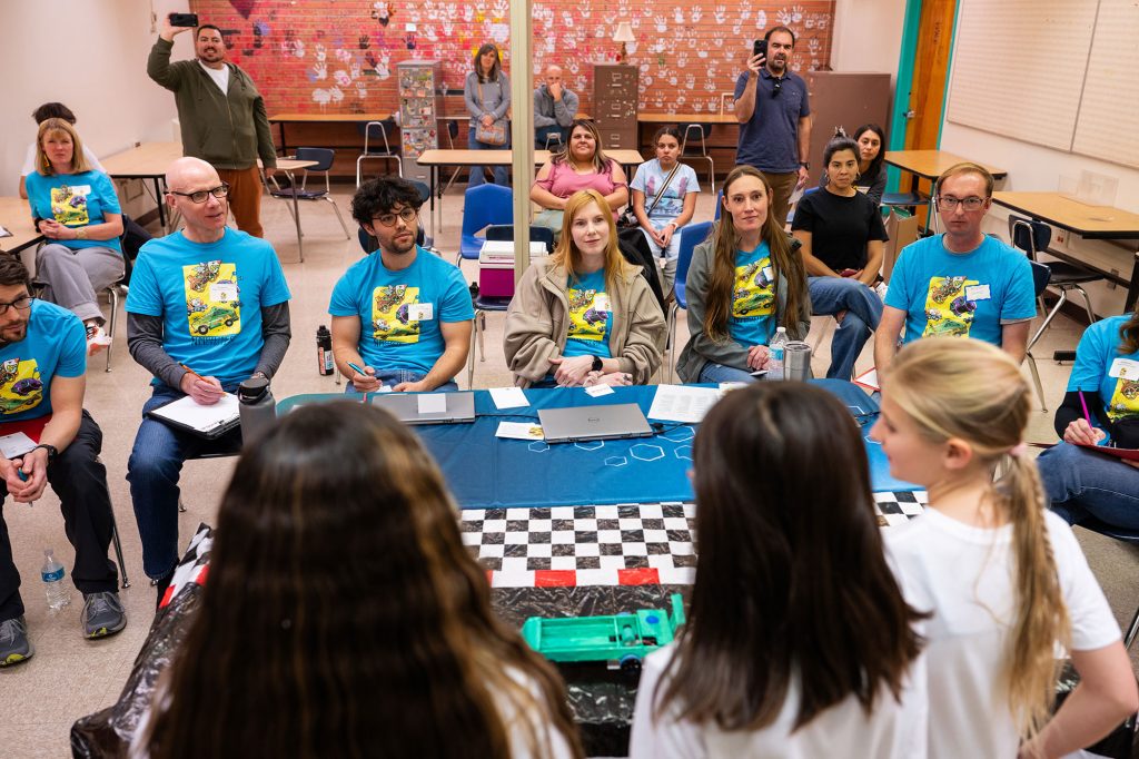 POWER AND DESIGN — The Republic of Pickle team from Chamisa Middle School in Los Alamos, presents their cars to judges during the design presentation portion of the New Mexico Electric Car Challenge. (Photo by Craig Fritz)