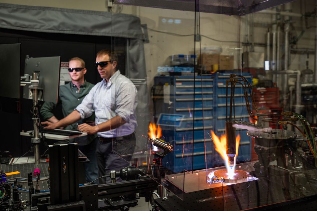 HOT STUFF — Sandia engineers test a thermal protection system material in an inductively coupled plasma torch. Material such as this protect hypersonic vehicles from the intense heat of traveling at more than 3,800 miles per hour. (Photo by Craig Fritz)