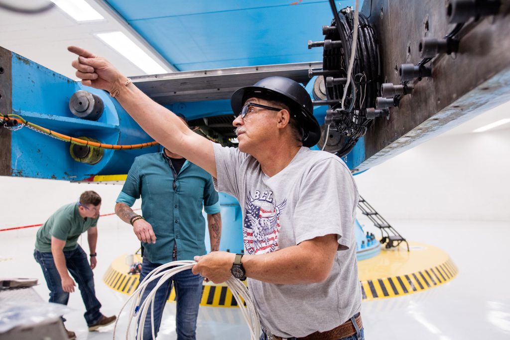 POWER UP — Technologist Freddie Martinez figures out electrical connections for testing of VIPER at the Superfuge. (Photo by David Lienemann)