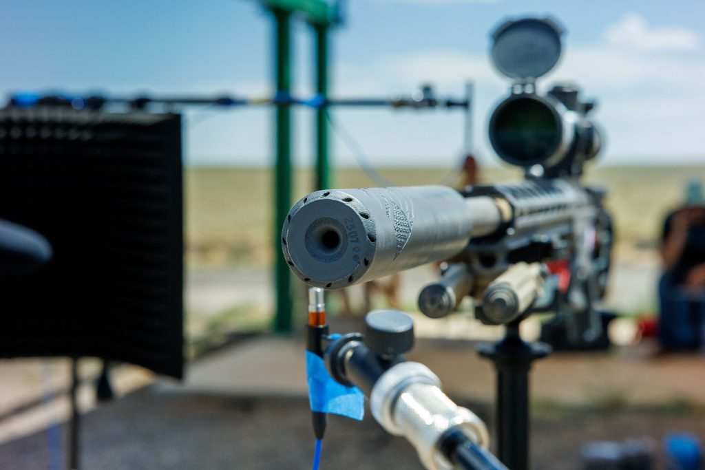 SURROUND SOUND — Sandia engineers placed multiple microphones around a Ridgeline Manufacturing suppressor during testing to record the sound at different points, then analyzed the data to determine impact on the human ear. (Photo by Bret Latter)