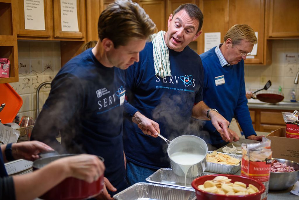 GIVING BACK — Josh Parsons, left, serves families in the Ronald McDonald House kitchen. (Photo courtesy of Josh Parsons)