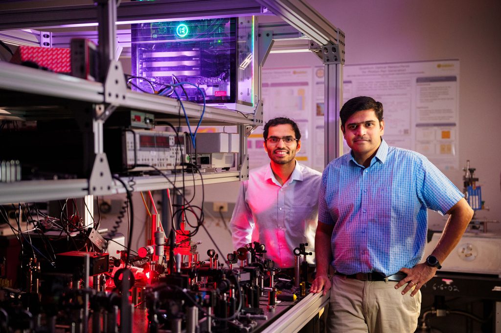 SELF-DRIVING LAB — Sandia scientists Saaketh Desai, left, and Prasad Iyer, modernized an optics lab with a team of artificial intelligences that learn data, design and run experiments, and interpret results. (Photo by Craig Fritz)