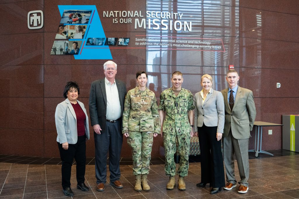 <strong>STRATCOM VISIT</strong> — From left, Sandia Deputy Labs Director Rita Gonzales; NNSA Sandia Field Office Manager Daryl Hauck; U.S. Army Command Sgt. Maj Jo Naumann, command senior enlisted leader of U.S. Strategic Command; USSTRATCOM Commander U.S. Navy Adm. Rich Correll; Labs Director Laura McGill; and USSTRATCOM Capability and Resource Integration Director Robert Taylor pose for a photo during a Feb. 11 visit and tour of the Labs. (Photo by Craig Fritz)