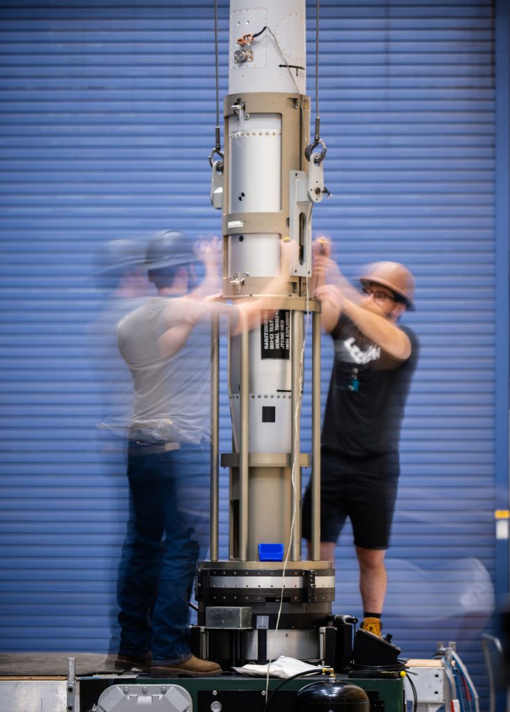 <strong>IN THE BALANCE</strong> — Mechanical engineers work with an inert B61-13 during mass properties testing.