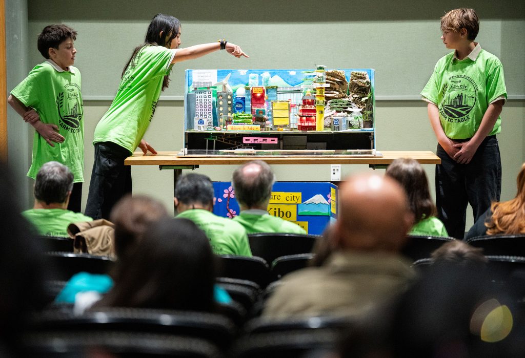 <strong>ON DISPLAY </strong>— From left, Isaiah Rodriguez, Elizabeth Hsu and Falco Bonner from Taos Municipal Charter’s Team Kibo present their model to judges at the New Mexico Future City Competition on Jan. 17. (Photo by Craig Fritz)