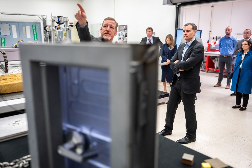 <strong>TECH VISIT</strong> — Chad Monthan, senior manager of Sandia Transportation Safeguards and Surety, presents various delayed access devices to NNSA Defense Nuclear Nonproliferation Deputy Administrator Matthew Napoli during his tour of Sandia Feb. 25. Hosted by leadership in Global Security, Napoli toured the Mobile Vault Staging Area, Counterfeit Detection Center and the Unmanned Aircraft Systems Lab, and received briefings on Sandia’s work in space, microelectronics and more. (Photo by Craig Fritz)